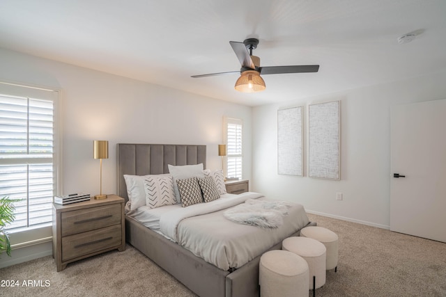 bedroom with ceiling fan and light carpet