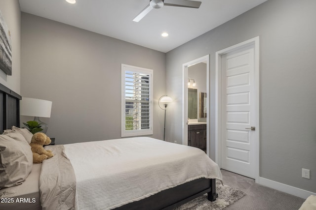 carpeted bedroom with connected bathroom and ceiling fan