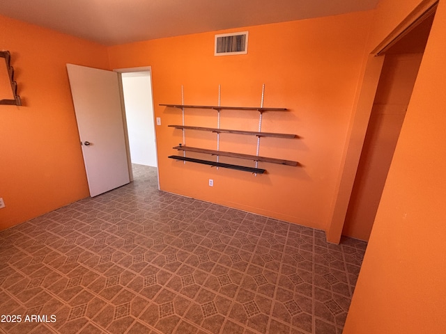 empty room featuring tile patterned floors and visible vents