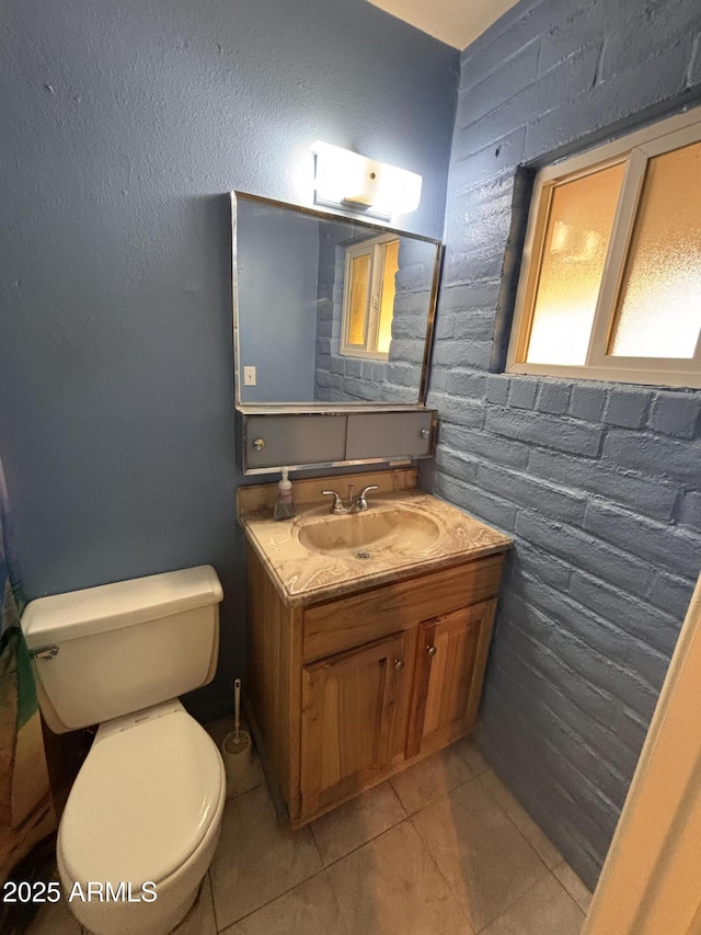 bathroom featuring tile patterned flooring, toilet, and vanity