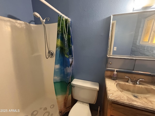 bathroom featuring vanity, toilet, a shower with shower curtain, and a textured wall