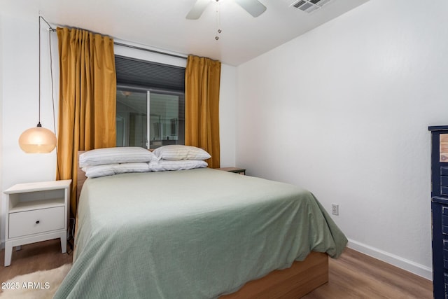 bedroom featuring wood-type flooring and ceiling fan