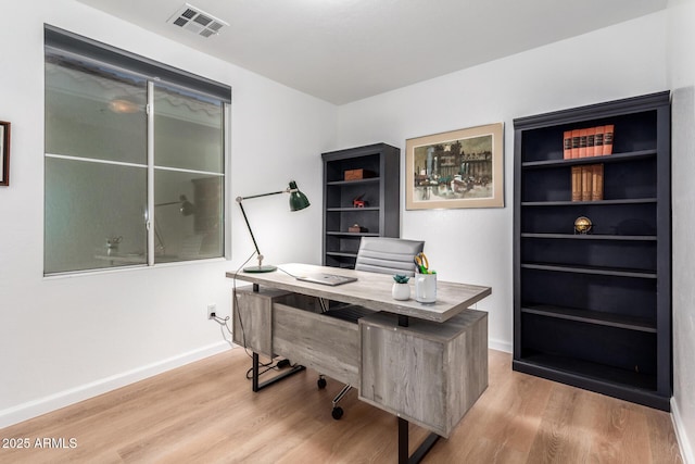 office area with light hardwood / wood-style floors