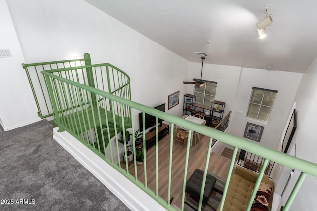 staircase featuring hardwood / wood-style flooring and ceiling fan