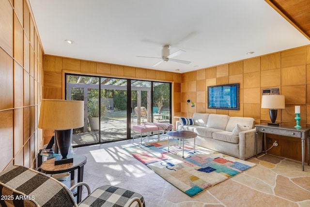 living room with wooden walls and ceiling fan