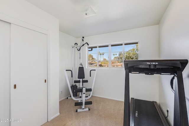 exercise room with light colored carpet