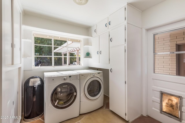 laundry room with cabinets and washing machine and clothes dryer