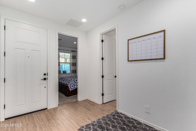 hall with light hardwood / wood-style floors