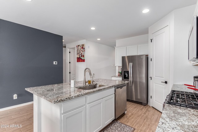 kitchen with sink, white cabinets, an island with sink, and appliances with stainless steel finishes