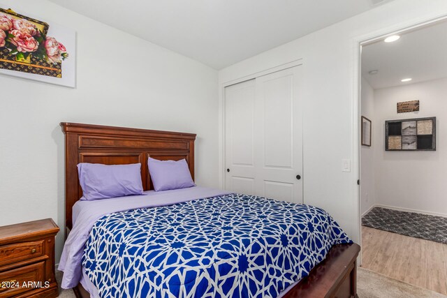 bedroom with a closet and hardwood / wood-style flooring