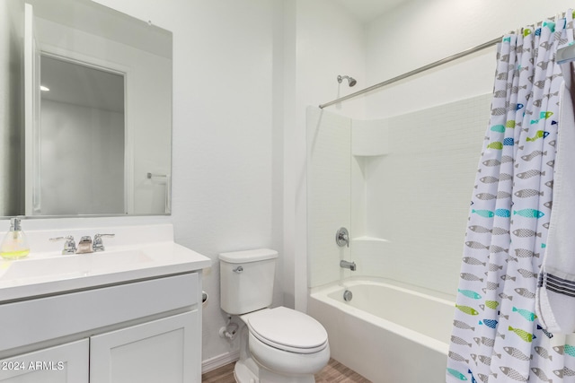 full bathroom with vanity, shower / bath combo, and toilet