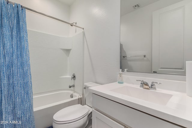 full bathroom featuring vanity, shower / bath combination with curtain, and toilet