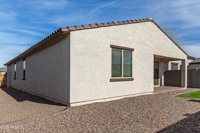 view of side of property with a patio