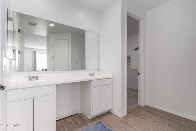 bathroom with hardwood / wood-style flooring and vanity