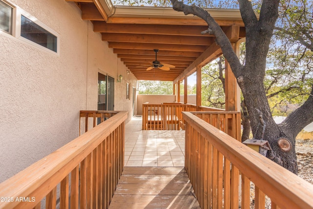 wooden terrace with a ceiling fan