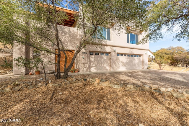 exterior space featuring a garage and stucco siding