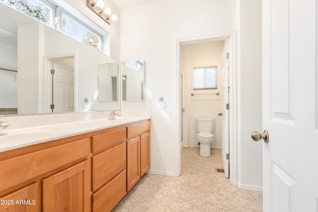 full bath with double vanity, carpet, a sink, and toilet