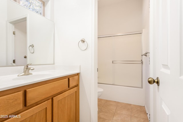 full bath with shower / bath combination with glass door, vanity, toilet, and tile patterned floors