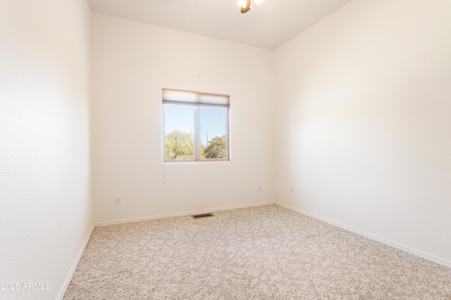 unfurnished room featuring carpet, visible vents, and baseboards