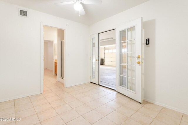 unfurnished room featuring visible vents, ceiling fan, baseboards, and light tile patterned flooring