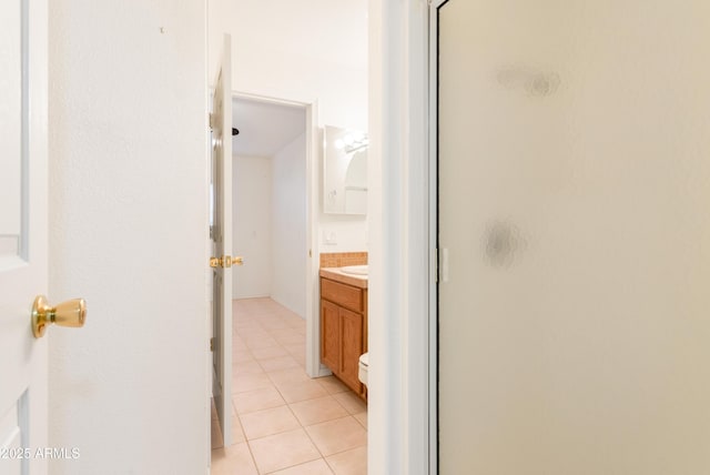 bathroom featuring a shower stall, tile patterned flooring, and vanity