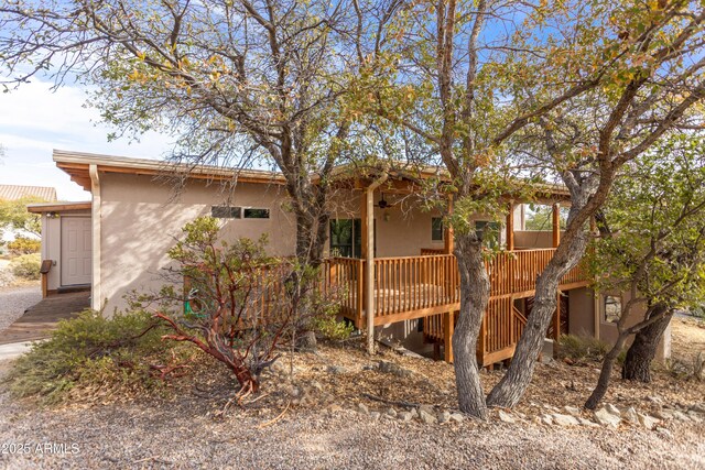 view of front facade featuring a deck and stucco siding