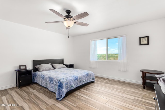 bedroom with ceiling fan and light hardwood / wood-style floors