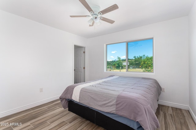 bedroom featuring ceiling fan and light hardwood / wood-style flooring