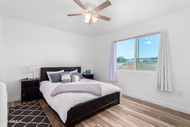 bedroom with hardwood / wood-style flooring and ceiling fan