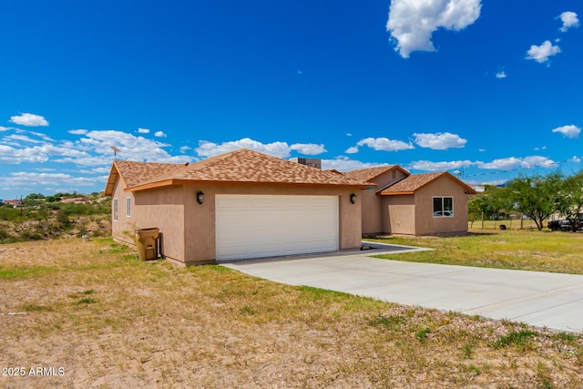 view of front of home with a garage and a front yard