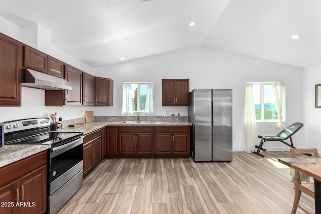 kitchen with light stone counters, appliances with stainless steel finishes, sink, and plenty of natural light