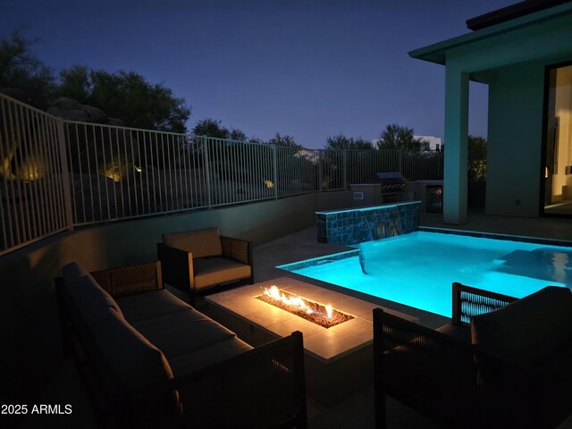28349 N 113th St, Scottsdale, AZ 85262 - pool at night with a patio, exterior kitchen, a pool with connected hot tub, and an outdoor living space with a fire pit