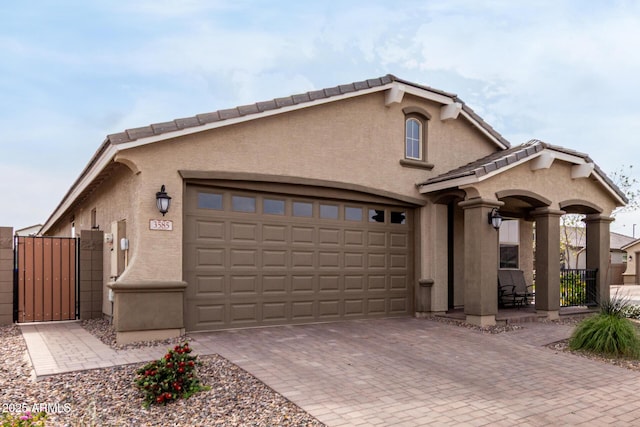 3585 W Oil Well Rd, San Tan Valley, AZ 85144 - view of front facade with a gate, fence, decorative driveway, an attached garage, and stucco siding
