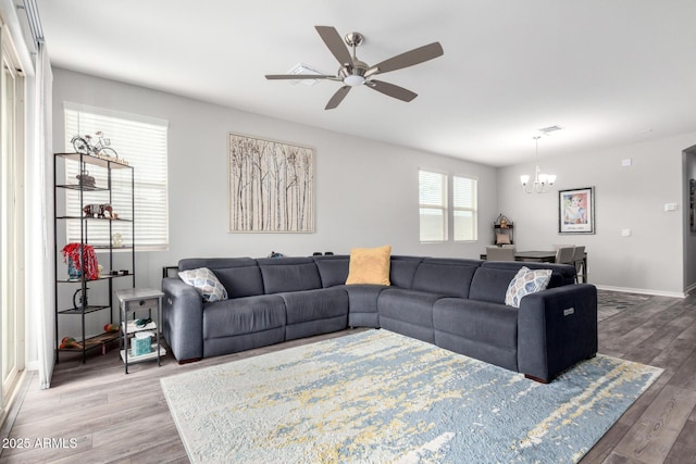 3585 W Oil Well Rd, San Tan Valley, AZ 85144 - living room with baseboards, wood finished floors, and ceiling fan with notable chandelier