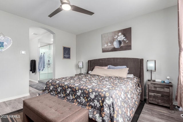 3585 W Oil Well Rd, San Tan Valley, AZ 85144 - bedroom featuring arched walkways, baseboards, wood finished floors, and a ceiling fan