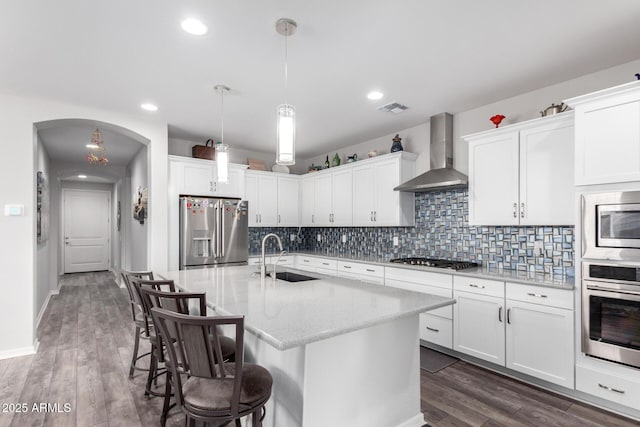 3585 W Oil Well Rd, San Tan Valley, AZ 85144 - kitchen with backsplash, a sink, wall chimney exhaust hood, stainless steel appliances, and visible vents
