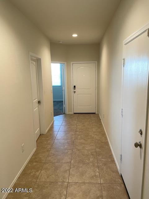 hall featuring light tile floors