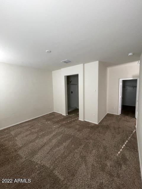 empty room with dark carpet