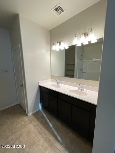 bathroom featuring dual vanity and tile floors