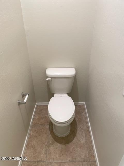 bathroom featuring toilet and tile floors