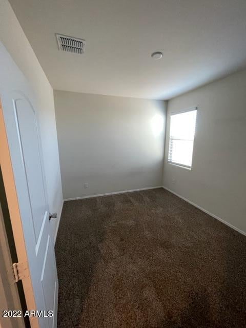 unfurnished room featuring carpet