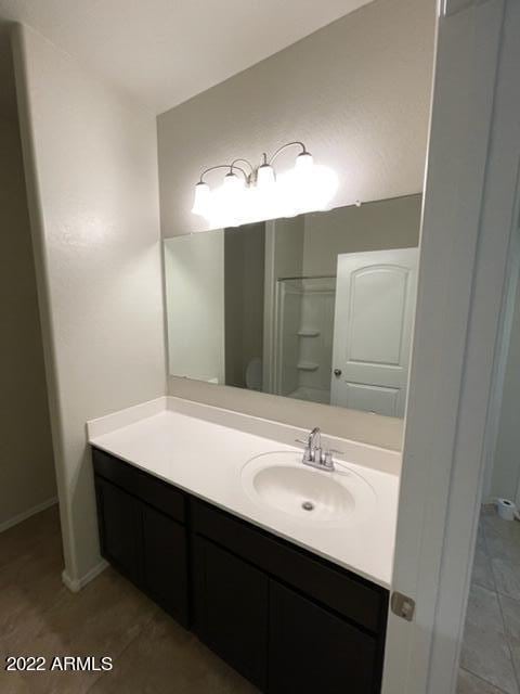 bathroom featuring tile flooring and vanity