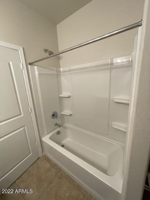 bathroom with tile floors and tub / shower combination