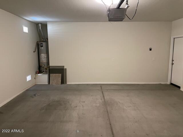 garage featuring gas water heater and a garage door opener