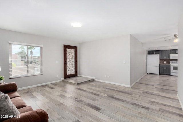 living room with ceiling fan and light hardwood / wood-style flooring