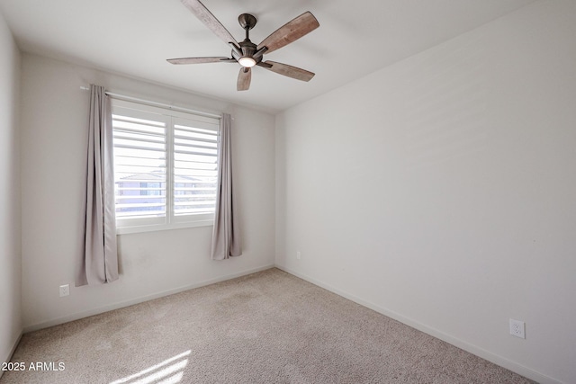 carpeted spare room with ceiling fan