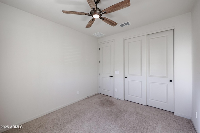 unfurnished bedroom with light carpet, a closet, and ceiling fan