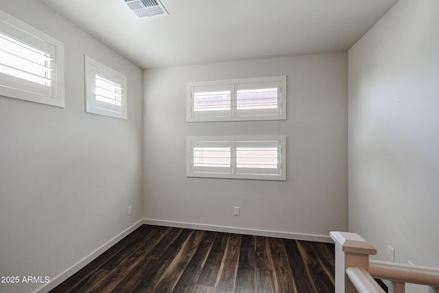 empty room with dark wood-type flooring