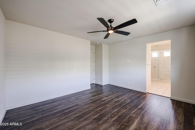 empty room with dark hardwood / wood-style floors and ceiling fan