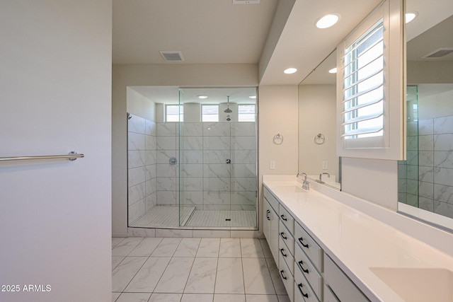 bathroom featuring vanity and a shower with shower door